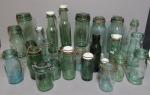 Collection de vingt-six bouteilles à conserve en verre moulé teinté,...