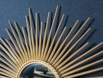 CHATY VALLAURIS - Miroir soleil en métal doré signé au...