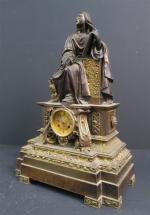 Pendule en bronze patiné et bronze doré représentant Saint-Jean l'Evangéliste,...