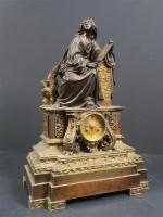 Pendule en bronze patiné et bronze doré représentant Saint-Jean l'Evangéliste,...