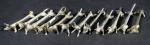 Douze porte-couteaux en métal argenté en forme d'animaux. Long :...