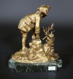 Jeune patineur du XVIII's attachant ses lames. Bronze doré sur...