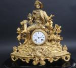 Pendule Napoléon III en régule doré à décor d'un jeune...